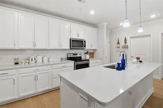 a large kitchen with kitchen island a sink a center island a dining table and chairs