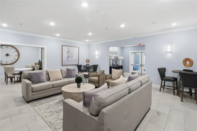 a living room with furniture and a floor to ceiling window