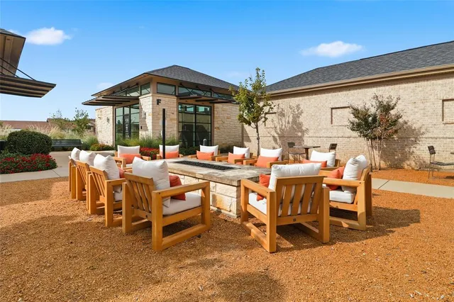 a living room with lots of furniture and view of kitchen