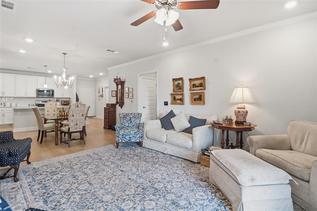 651 Watters Road, Unit 8202 Allen, TX 75013 - Photo 8 of 32 a living room with furniture and a chandelier