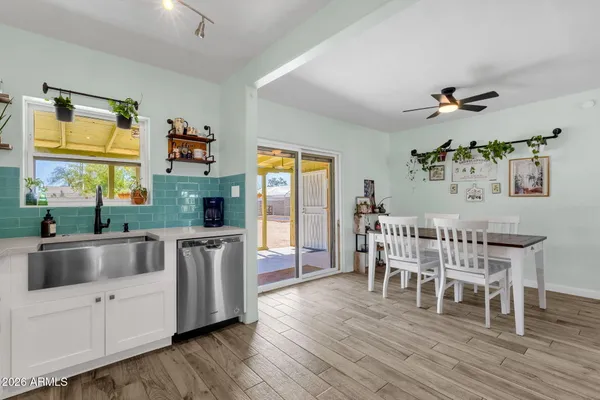 a kitchen with stainless steel appliances a dining table chairs and chandelier