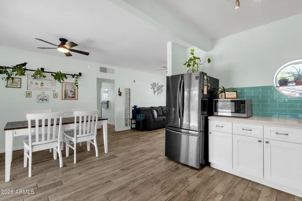 a kitchen with stainless steel appliances white cabinets a sink and a stove