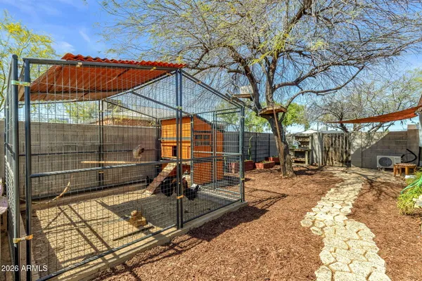 a backyard of a house with oven and tree