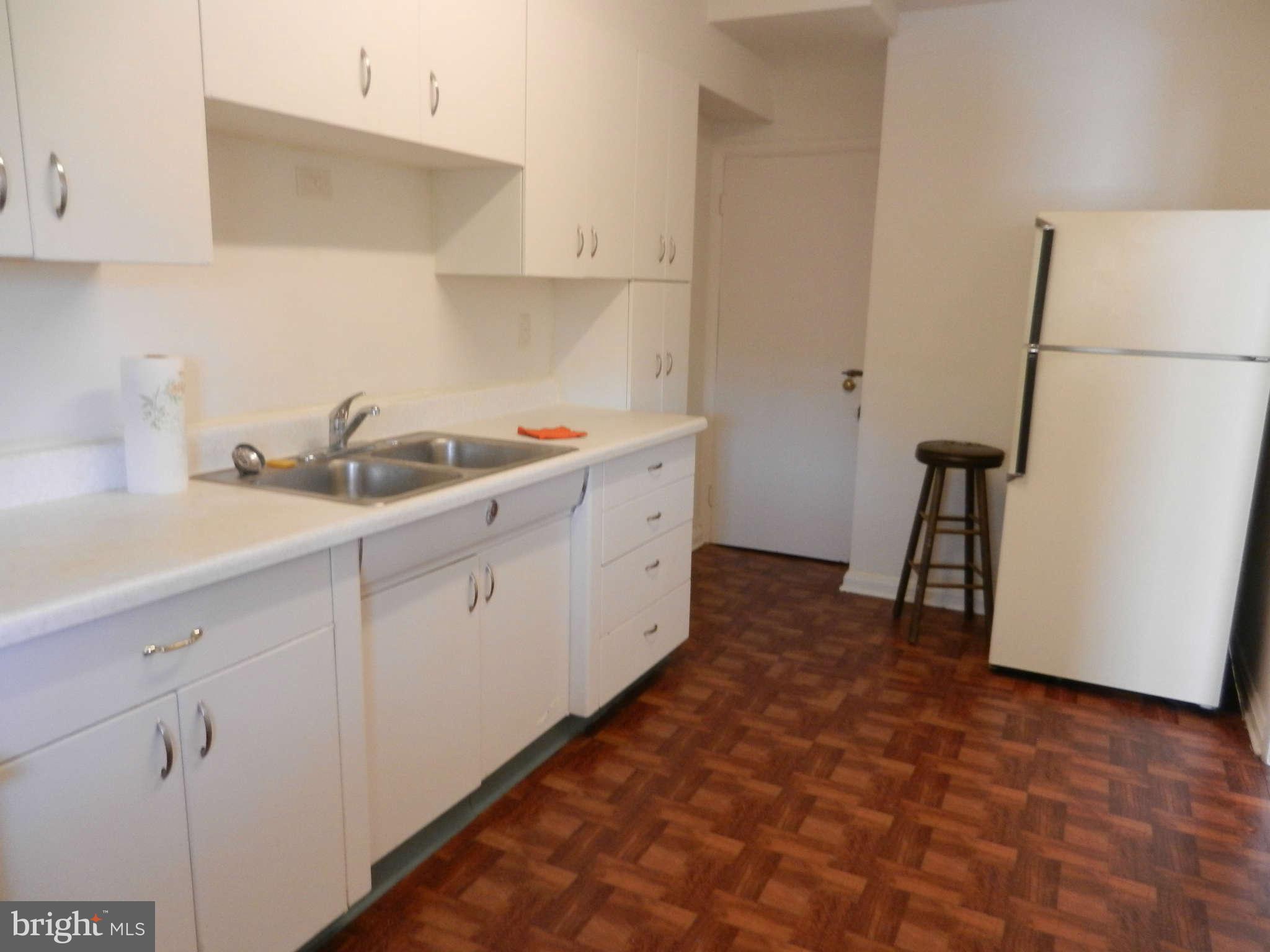 6124 Marlora Road Baltimore, MD 21239 - Photo 5 of 12 a kitchen with sink cabinets and window