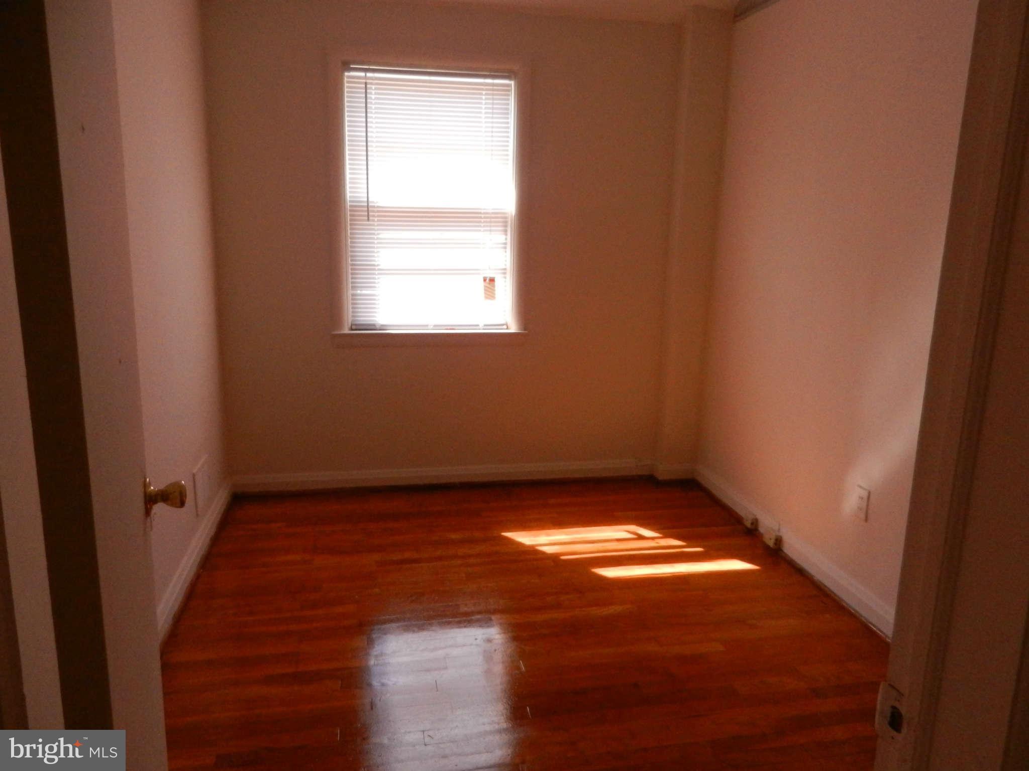 6124 Marlora Road Baltimore, MD 21239 - Photo 8 of 12 a view of an empty room and window