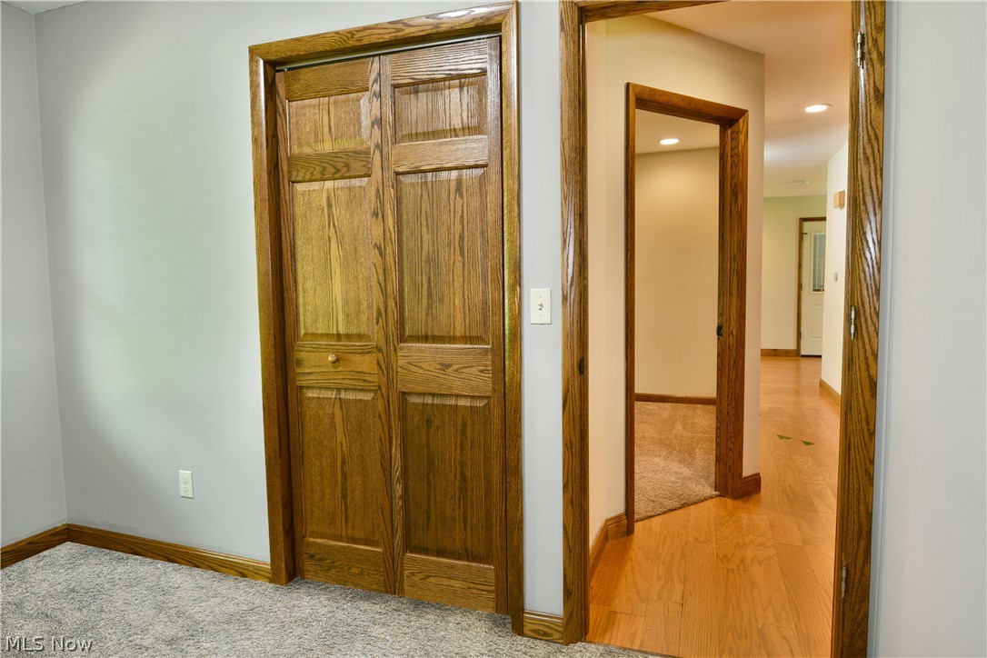 754 Warner Road Hubbard, OH 44425 - Photo 32 of 46 Wood-finish bi-fold closet doors paired with matching wood-finish trim and baseboards