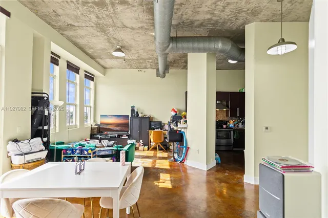 a living room with fireplace furniture and a large window