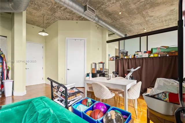 a view of a hallway with workspace and a window