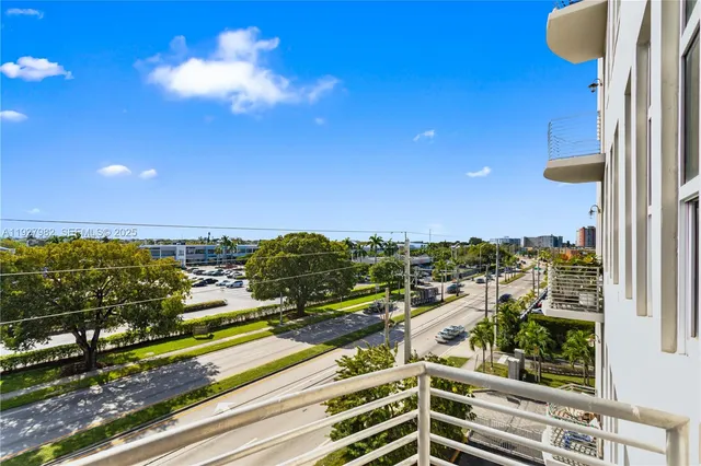 a bedroom with two beds and large windows