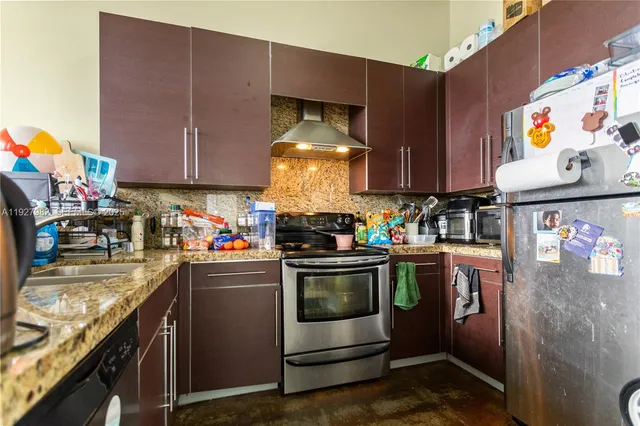 a kitchen with a sink and a stove top oven