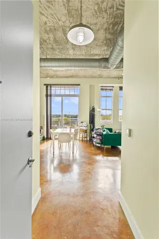 a view of a room with workspace and a chandelier