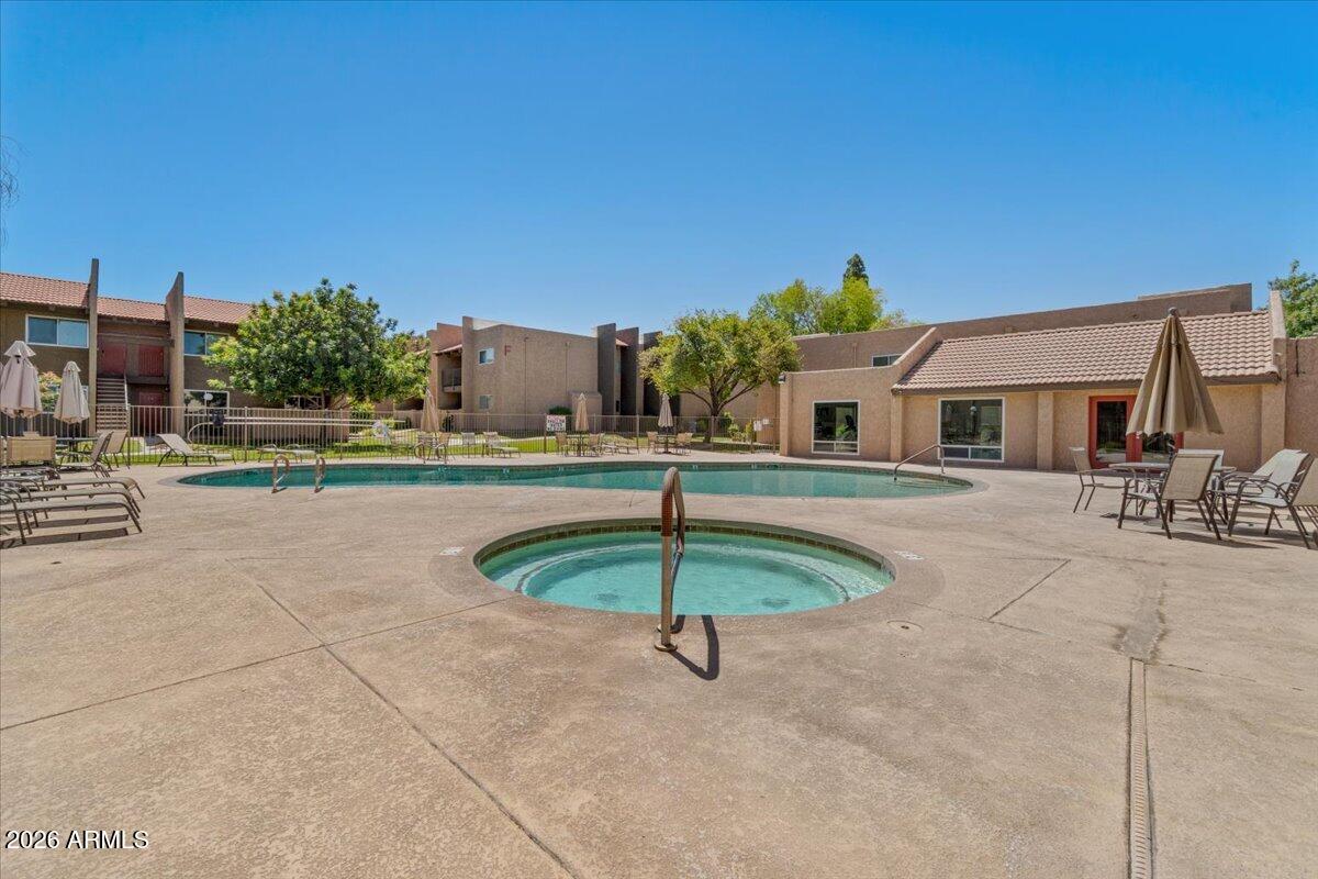 5525 East Thomas Road, Unit O12 Phoenix, AZ 85018 - Photo 18 of 27 a backyard of a house with table and chairs