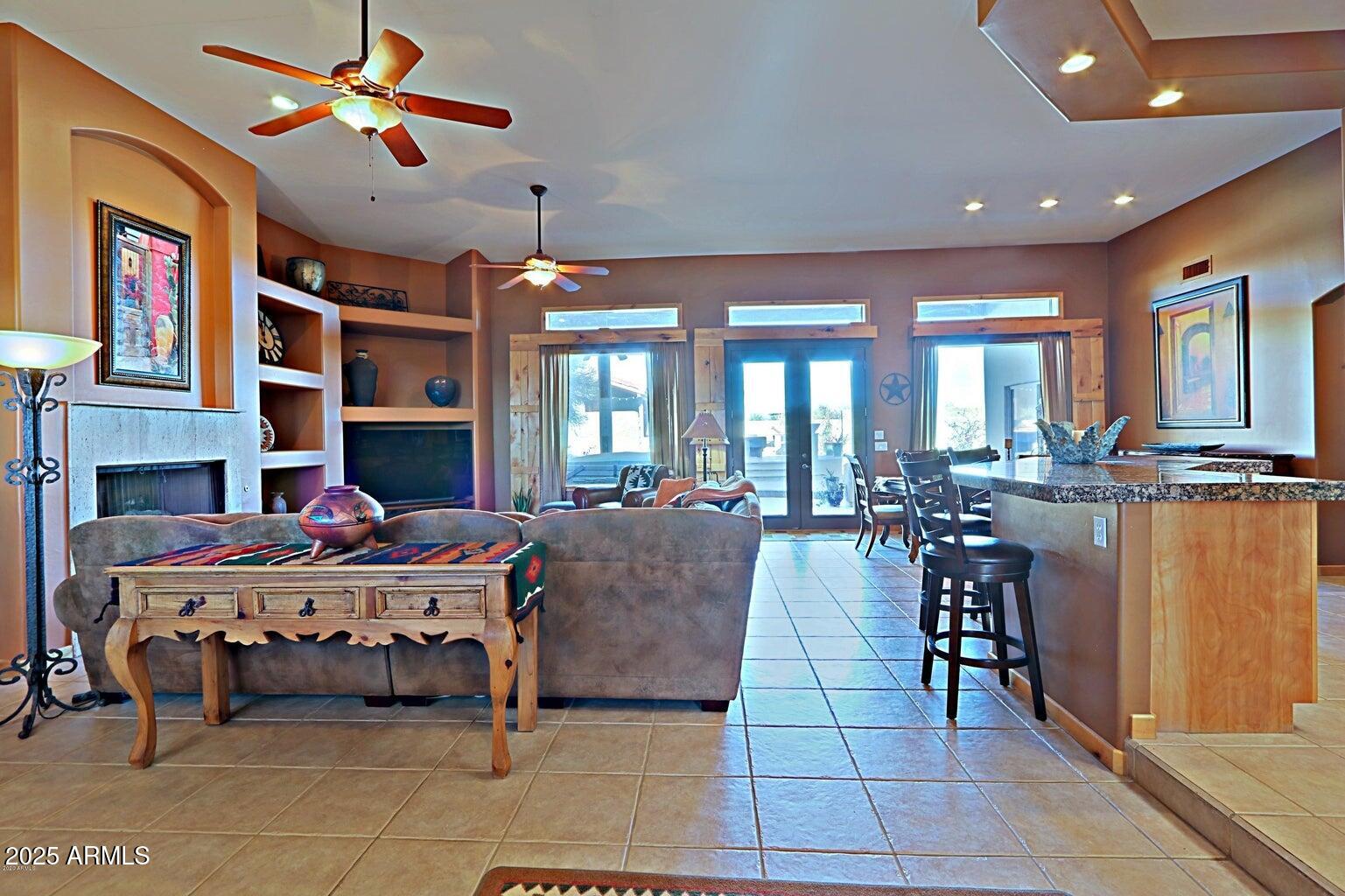15320 East Skinner Drive Scottsdale, AZ 85262 - Photo 13 of 21 a living room with fireplace furniture and a chandelier