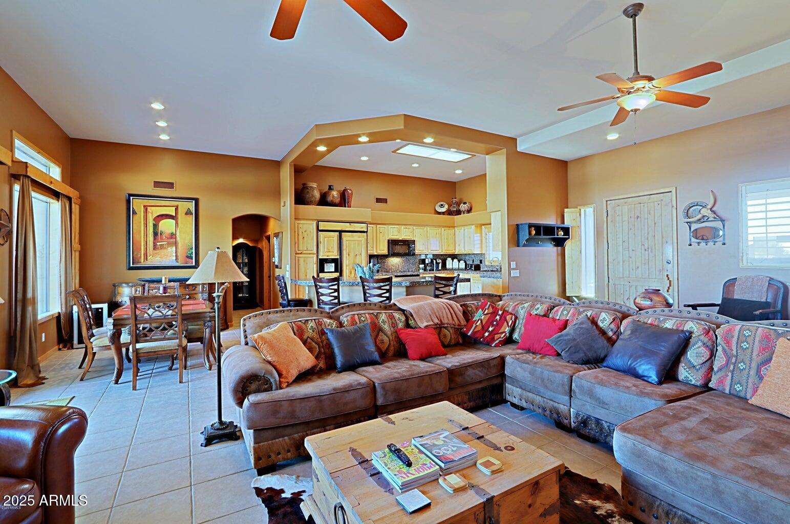 15320 East Skinner Drive Scottsdale, AZ 85262 - Photo 8 of 21 a living room with furniture a chandelier and a dining table