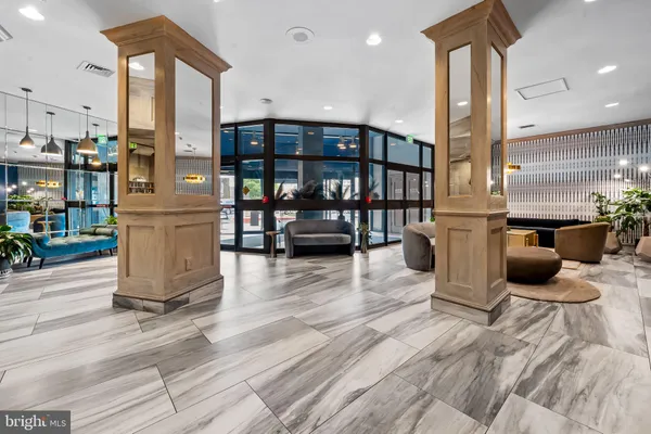 a living room with furniture and a floor to ceiling window