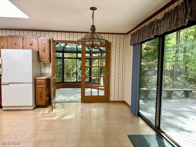 3422 Southern Road Richfield, OH 44286 - Photo 15 of 42 Kitchen with pendant lighting, a chandelier, white refrigerator, and a healthy amount of sunlight