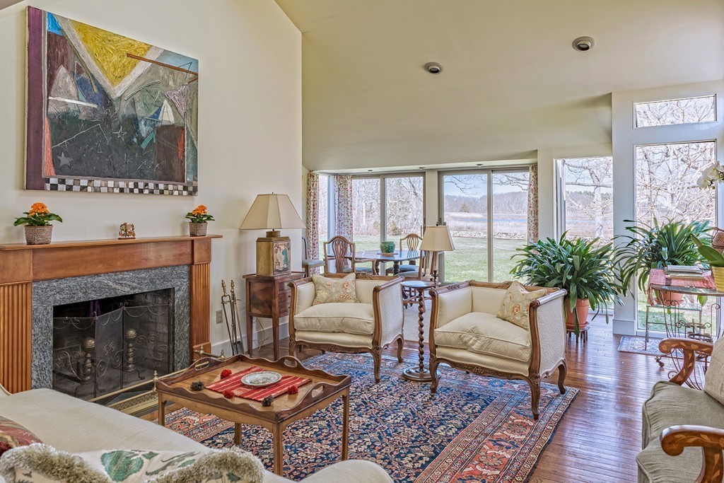 134 Argilla Road Ipswich, MA 01938 - Photo 5 of 10 a living room with furniture fireplace and a large window