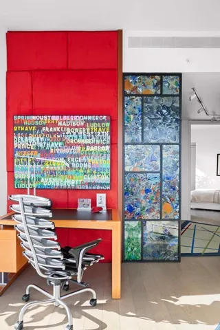 a living room with patio furniture and a potted plant