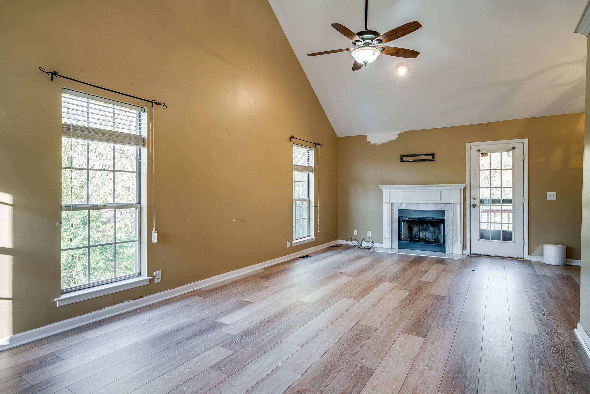 2302 Rader Ridge Road Antioch, TN 37013 - Photo 3 of 19 wooden floor fireplace and windows in an empty room