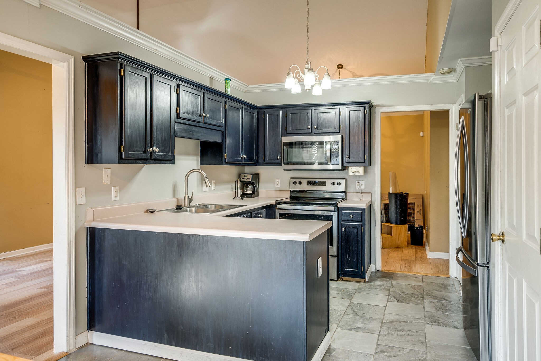 2302 Rader Ridge Road Antioch, TN 37013 - Photo 7 of 19 a kitchen with kitchen island granite countertop stainless steel appliances a stove refrigerator sink and microwave