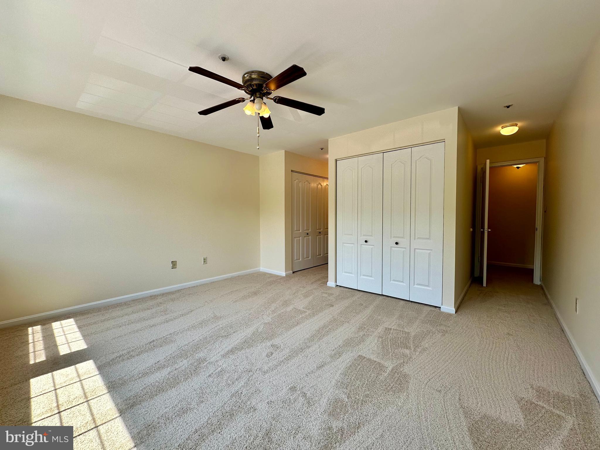 8493 Falls Run Road, Unit D Ellicott City, MD 21043 - Photo 33 of 44 Primary bedroom w/ new carpet, paint, en-suite