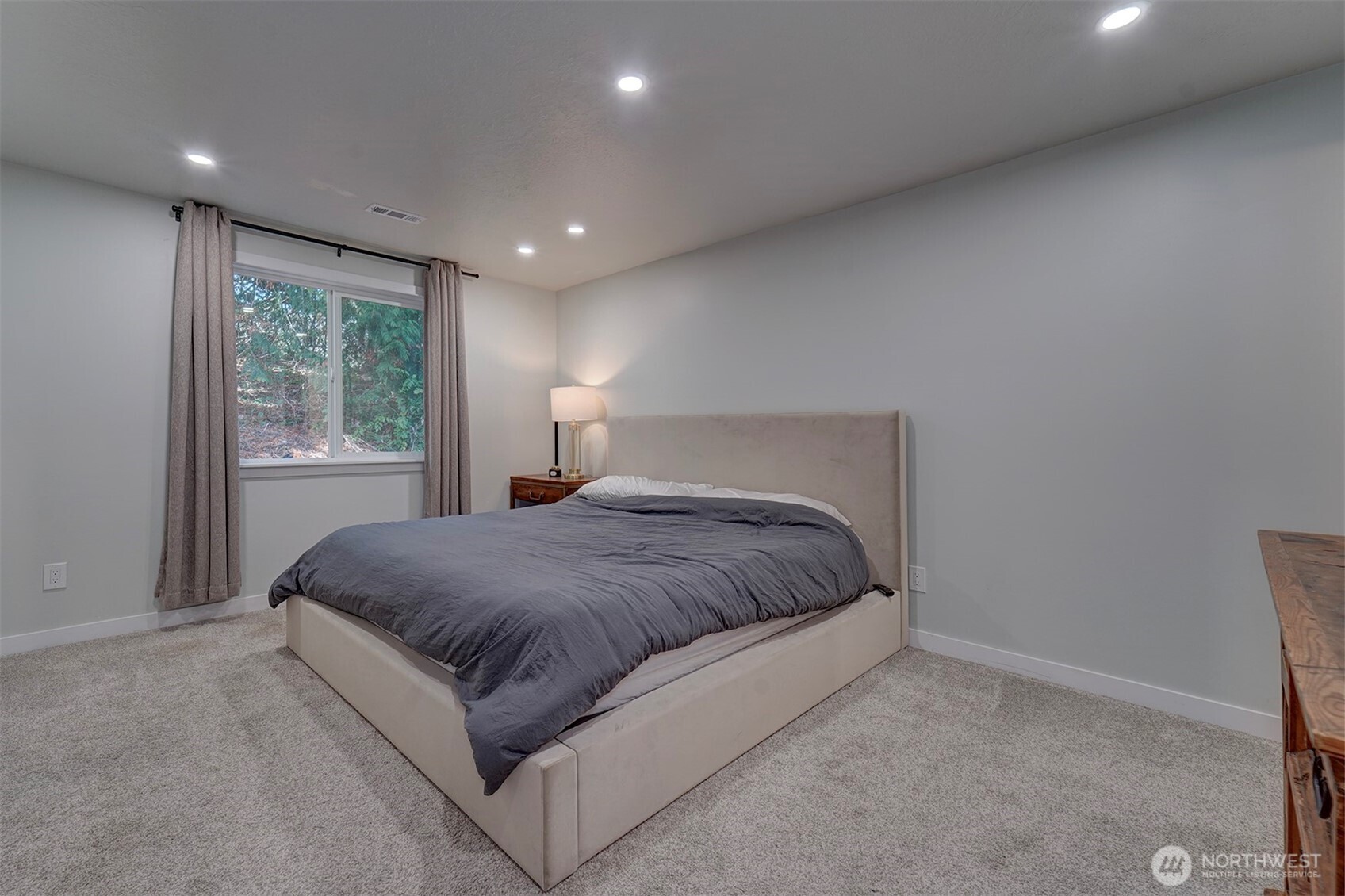 4931 Knute Anderson Road Northwest Silverdale, WA 98383 - Photo 18 of 37 a spacious bedroom with a bed and a window