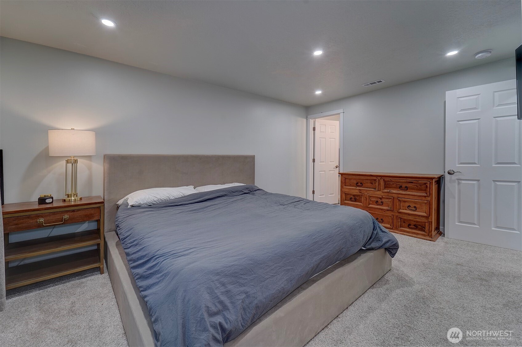 4931 Knute Anderson Road Northwest Silverdale, WA 98383 - Photo 19 of 37 a bedroom with a bed and a lamp