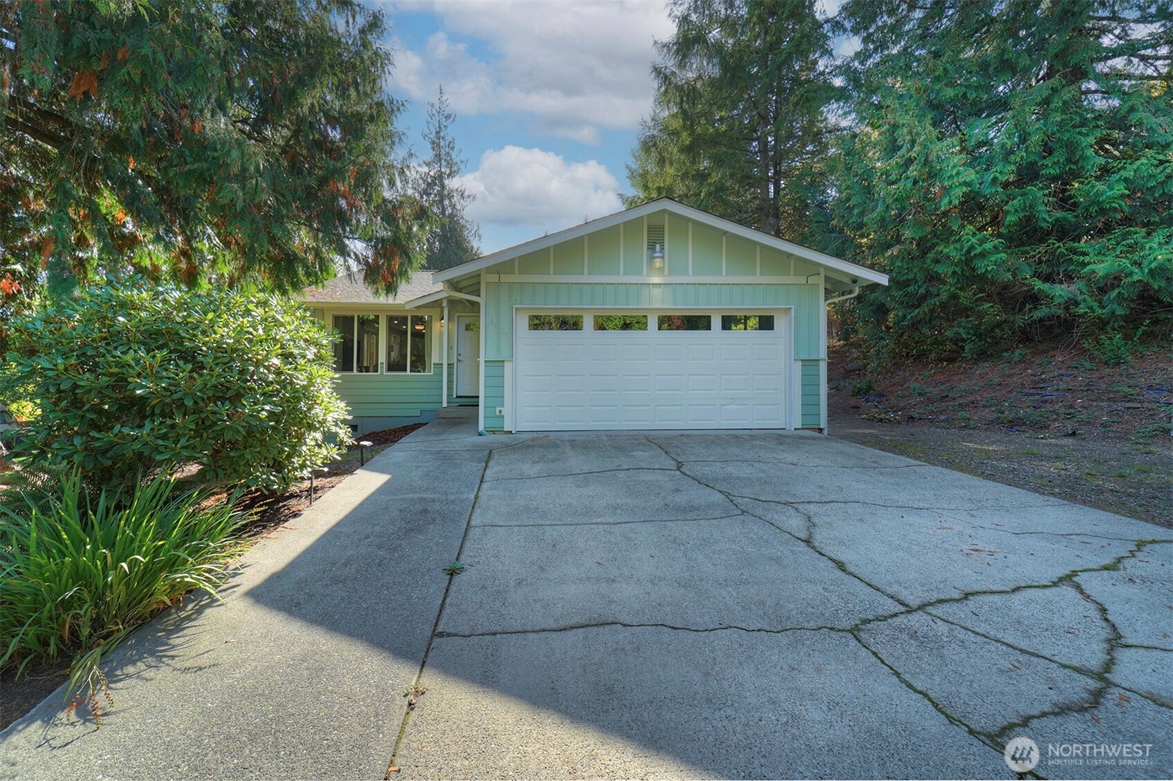 4931 Knute Anderson Road Northwest Silverdale, WA 98383 - Photo 2 of 37 a front view of house with yard and trees