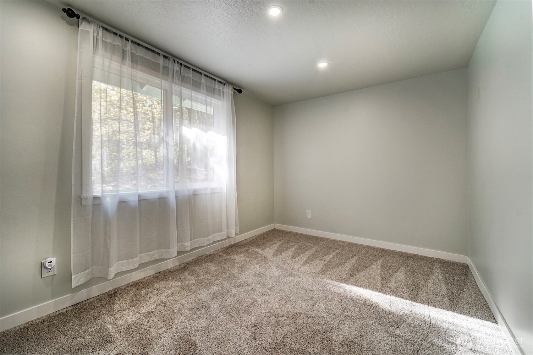 4931 Knute Anderson Road Northwest Silverdale, WA 98383 - Photo 22 of 37 an empty room with windows