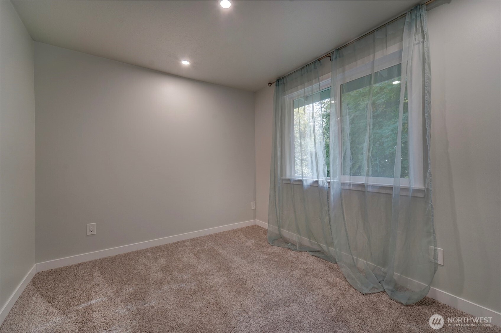 4931 Knute Anderson Road Northwest Silverdale, WA 98383 - Photo 24 of 37 a view of an empty room with a window