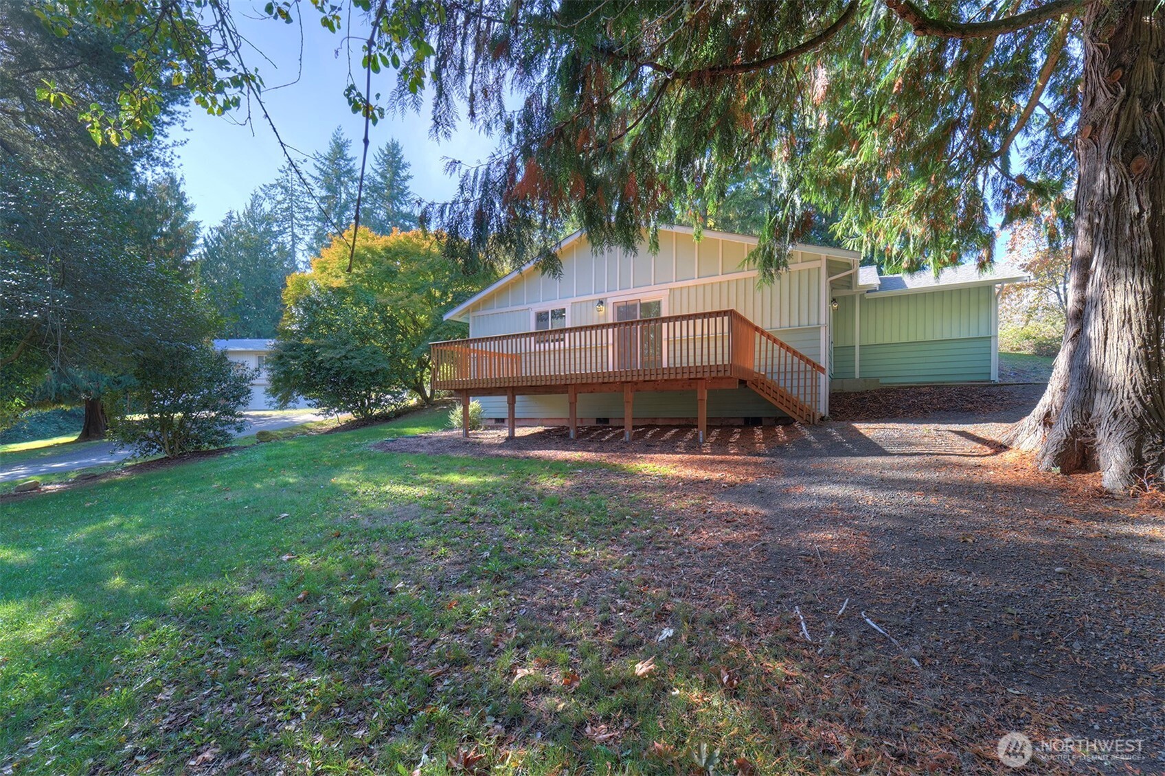 4931 Knute Anderson Road Northwest Silverdale, WA 98383 - Photo 35 of 37 a view of a house with a yard and a large tree