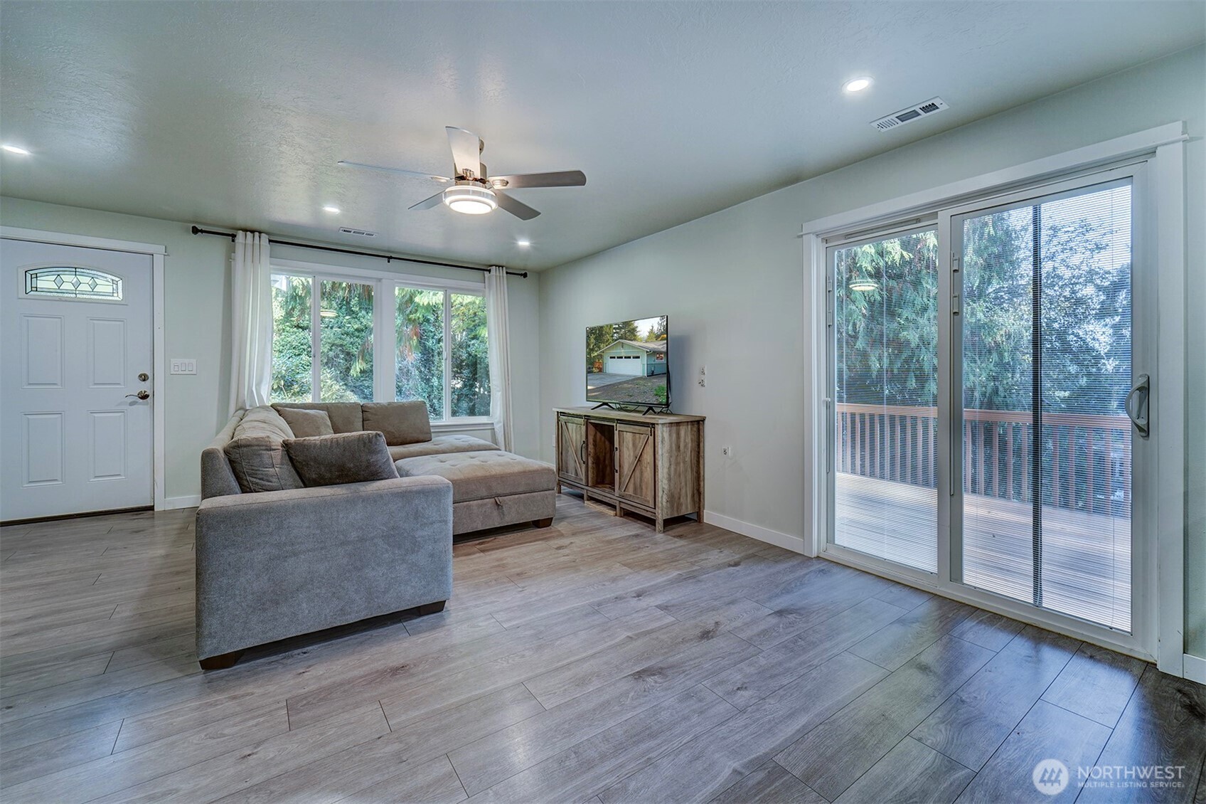 4931 Knute Anderson Road Northwest Silverdale, WA 98383 - Photo 7 of 37 a living room with furniture and a large window