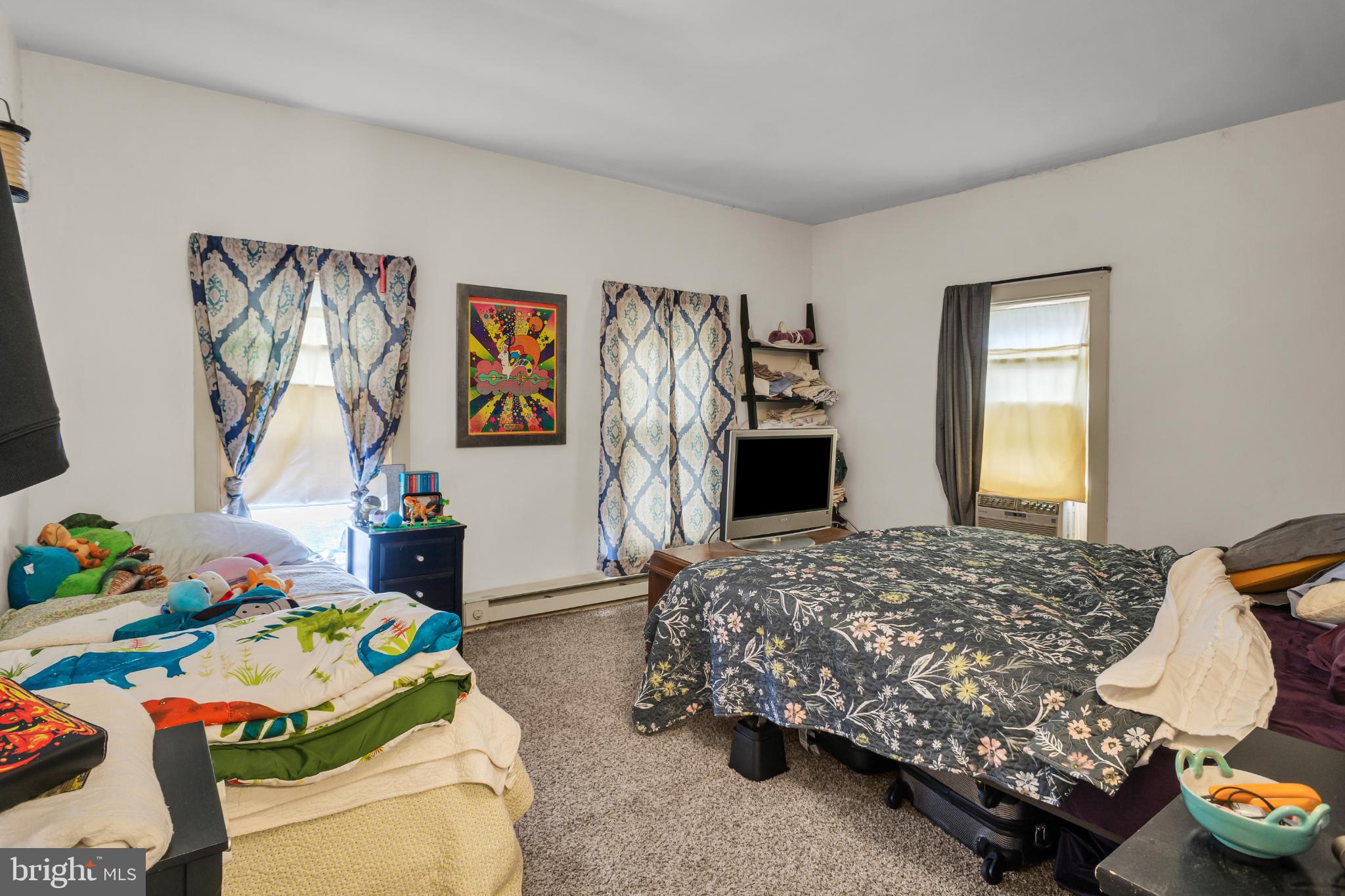 81 1st Avenue, Unit E Red Lion, PA 17356 - Photo 16 of 19 Cozy bedroom with vibrant decor and light.