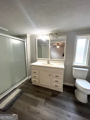 a bathroom with a double vanity sink toilet and shower