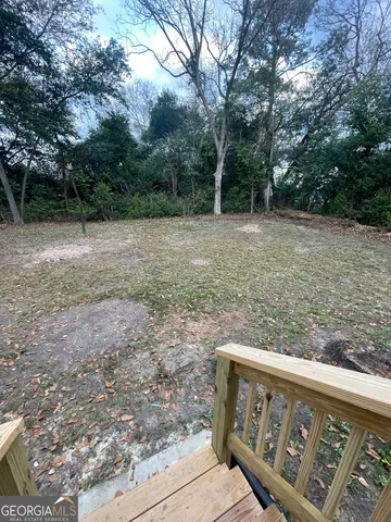 a view of outdoor space with deck and yard