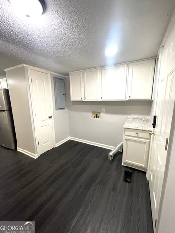 an entryway with wooden floor and cabinet