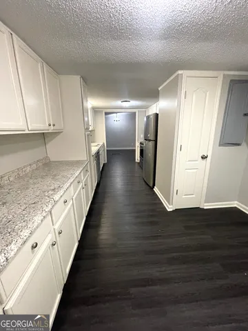 a view of hallway with wooden floor