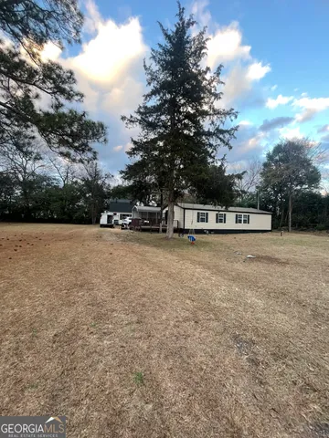 a view of swimming pool with trees in the background