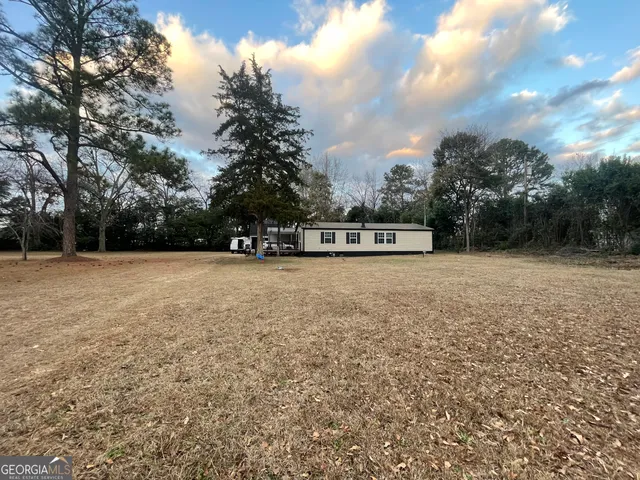 a view of outdoor space with deck and trees