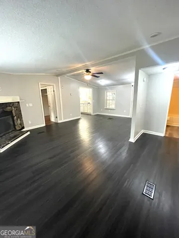 a view of a room with wooden floor