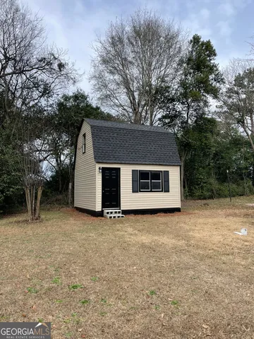 a house that has a tree in front of it