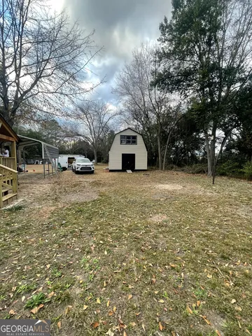 a view of a house with a yard covered with snow