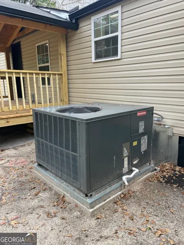 a view of a house with a wooden deck