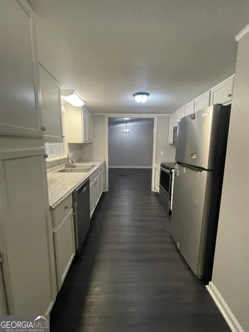 a kitchen with stainless steel appliances a refrigerator and a sink