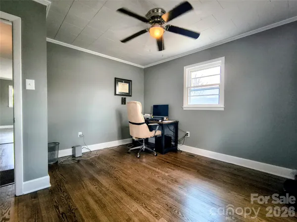 a workspace with wooden floor and a window