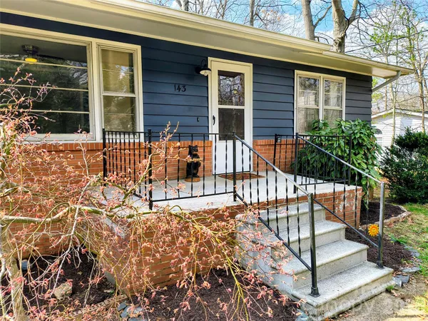 a view of house with backyard and porch
