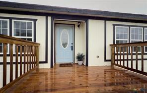 Property entrance with a wooden deck