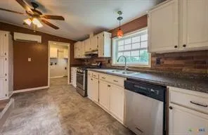 a kitchen with a sink stove and a refrigerator