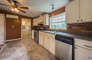 3627 North Katy Road Ross, TX 76640 - Photo 11 of 31 a kitchen with a sink appliances cabinets and a window
