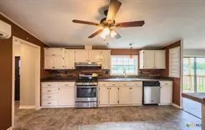 a kitchen with a stove a sink and a refrigerator